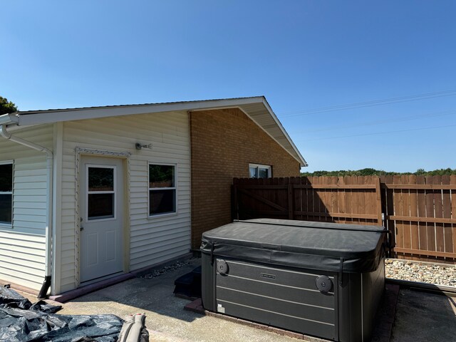 2065 S Lapeer Rd, Lapeer, MI 48446 - view of side of home with a hot tub and brick siding