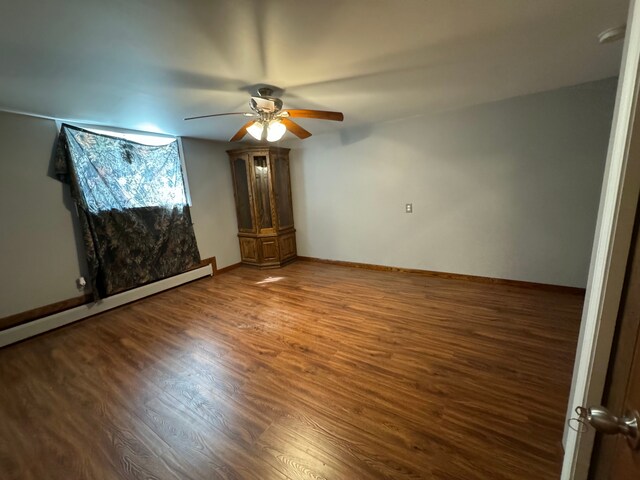 2065 S Lapeer Rd, Lapeer, MI 48446 - empty room featuring ceiling fan, wood finished floors, baseboard heating, and baseboards