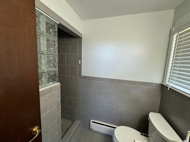 2065 S Lapeer Rd, Lapeer, MI 48446 - full bath featuring a baseboard radiator, toilet, walk in shower, tile walls, and a wainscoted wall