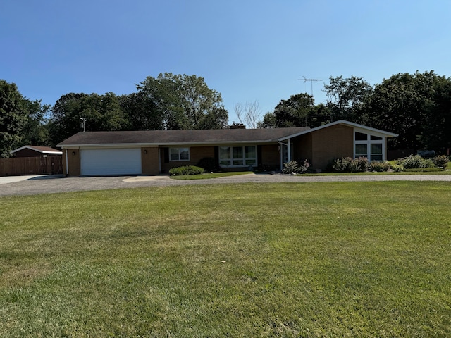 single story home featuring a front yard and a garage