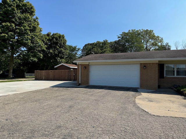 2065 S Lapeer Rd, Lapeer, MI 48446 - view of home's exterior with asphalt driveway, brick siding, and an attached garage