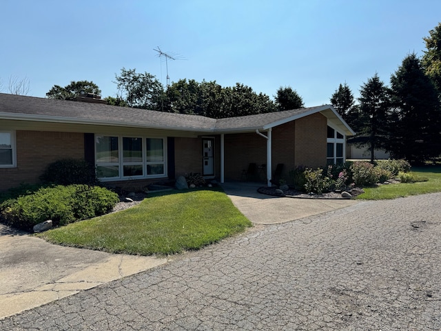 2065 S Lapeer Rd, Lapeer, MI 48446 - ranch-style home with brick siding and a front lawn
