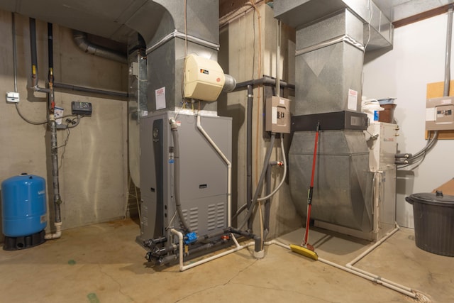 utility room featuring heating unit