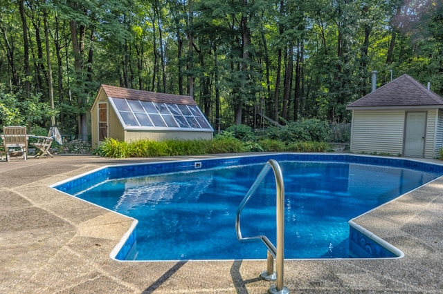 view of pool with a patio area and an outdoor structure