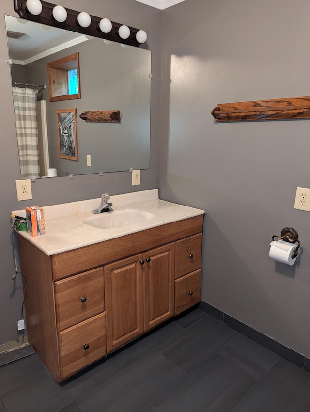 bathroom with tile patterned flooring, vanity, and ornamental molding