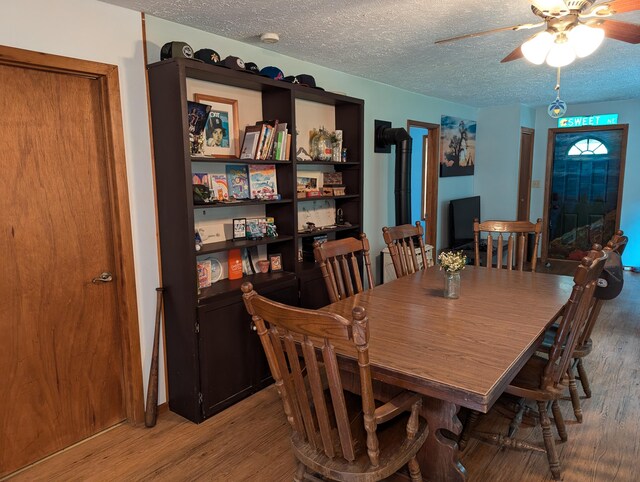 3290 Riverview Dr, Hersey, MI 49639 - dining space with wood finished floors, a textured ceiling, and ceiling fan