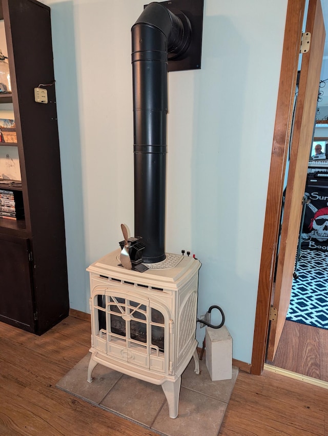 details with hardwood / wood-style floors and a wood stove