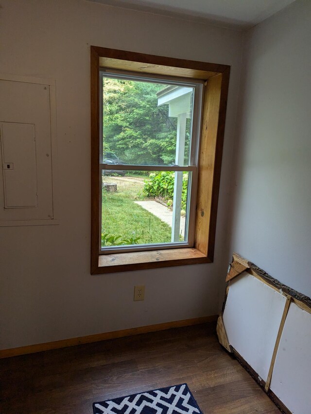 3290 Riverview Dr, Hersey, MI 49639 - empty room featuring electric panel, dark wood-style floors, and baseboards