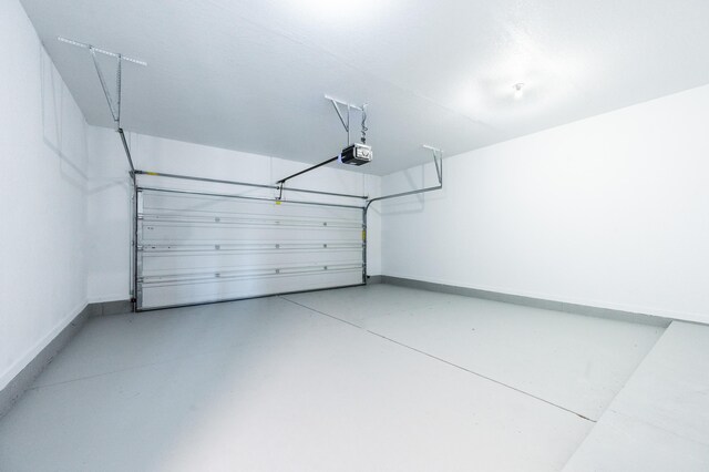 717 Tioga Park Unit 717, Big Rapids, MI 49307 - garage featuring a garage door opener and baseboards