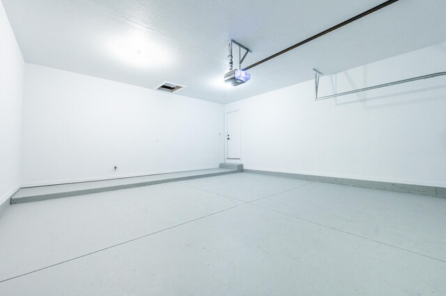 717 Tioga Park Unit 717, Big Rapids, MI 49307 - garage with a garage door opener and baseboards