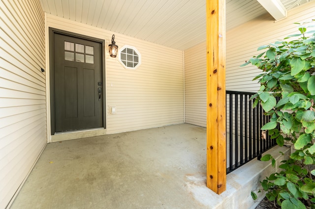 view of exterior entry with a porch