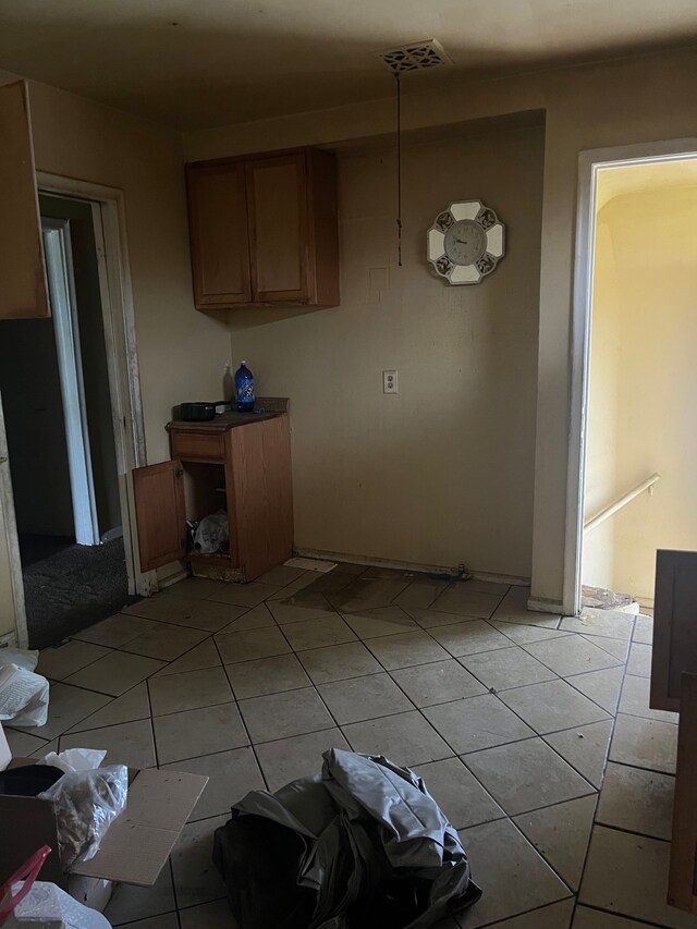 5130 E Outer Dr, Detroit, MI 48234 - kitchen featuring light tile patterned floors and brown cabinets