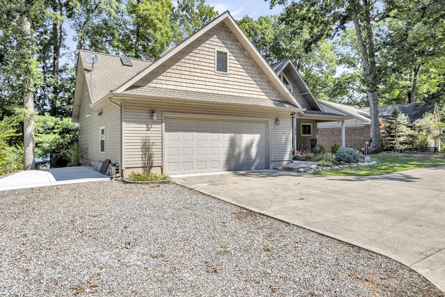1620 Little Dr, Horton, MI 49246 - view of front facade featuring driveway, an attached garage, and roof with shingles