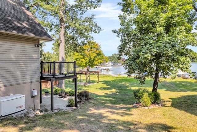 view of yard with a patio area and a deck with water view