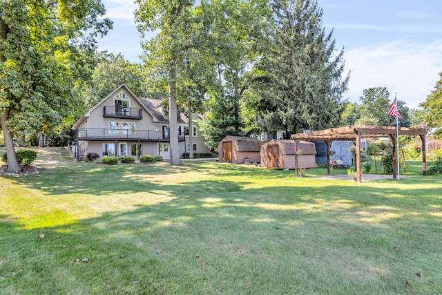 view of yard featuring an outbuilding, a pergola, a storage shed, and a balcony