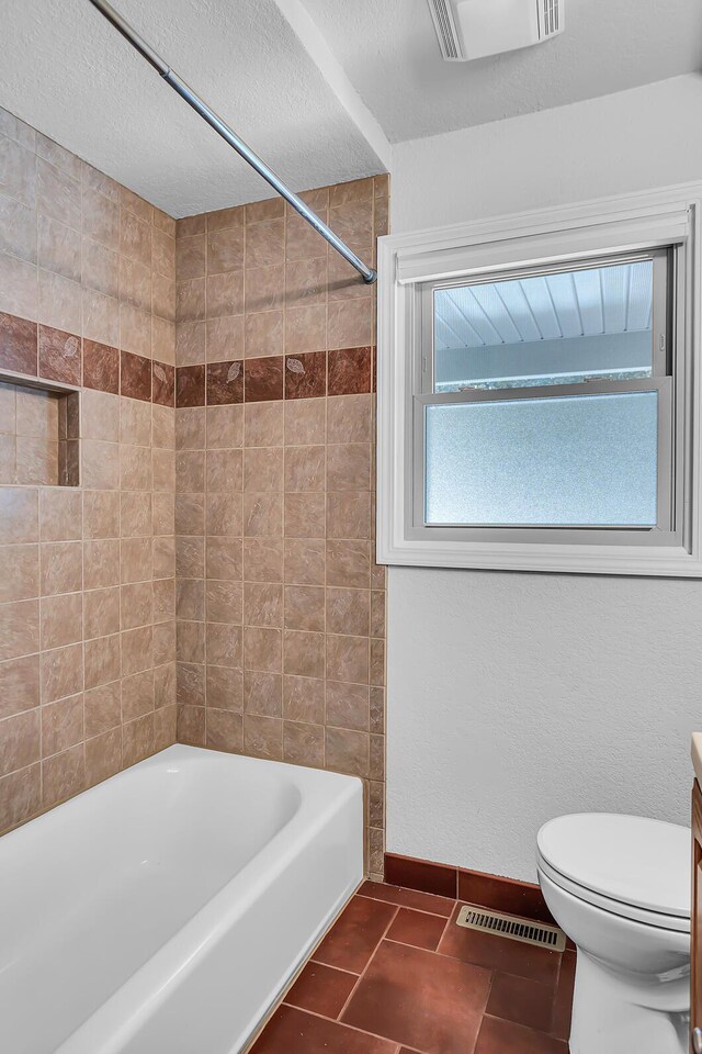 1620 Little Dr, Horton, MI 49246 - full bath featuring toilet, baseboards, shower / bathtub combination, tile patterned floors, and a textured ceiling