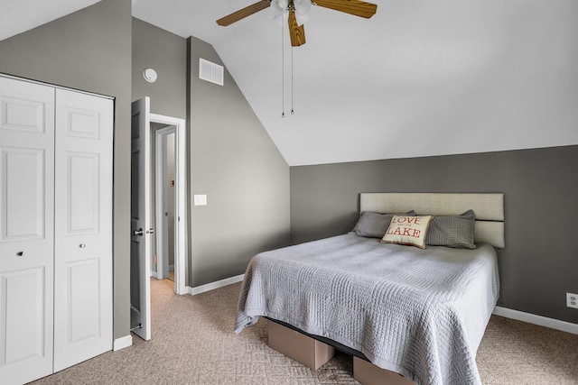 bedroom featuring a closet, baseboards, lofted ceiling, and carpet floors