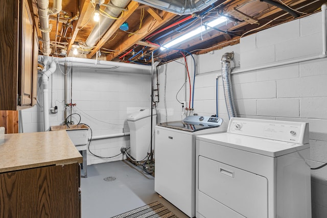 washroom with washing machine and dryer and laundry area