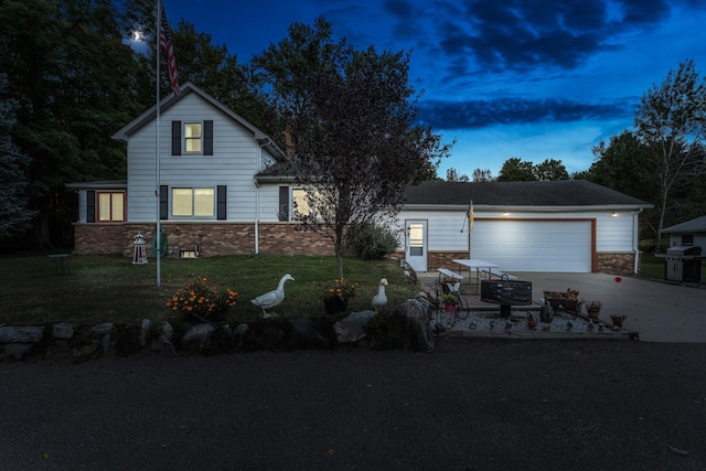 view of front of house with a garage and a lawn