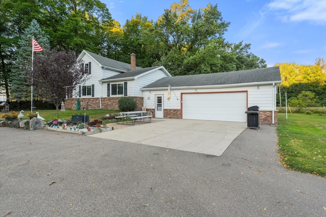 view of front facade with a front yard and a garage