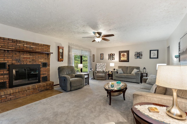 carpeted living room featuring ceiling fan, a fireplace, and a textured ceiling