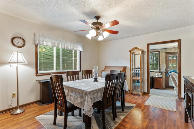 dining room with a textured ceiling, light hardwood / wood-style flooring, and ceiling fan