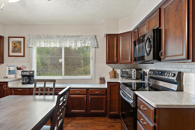 kitchen featuring stainless steel electric stove, decorative backsplash, dark wood-type flooring, and a textured ceiling