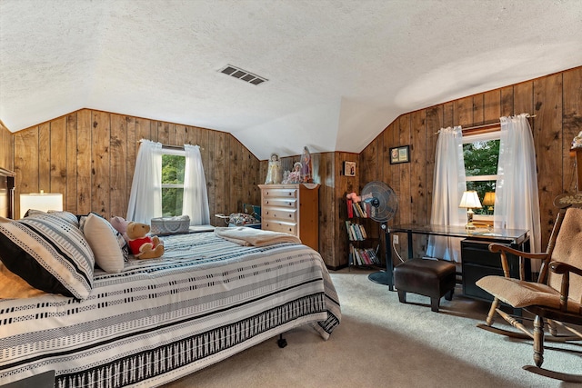 carpeted bedroom featuring multiple windows, wood walls, and vaulted ceiling