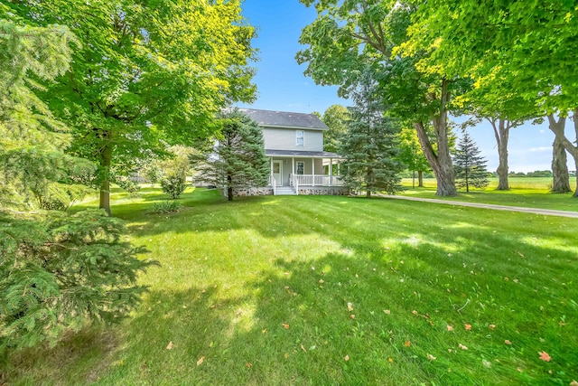 view of yard featuring covered porch