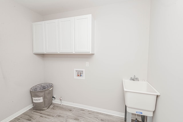 laundry area featuring gas dryer hookup, cabinets, washer hookup, and sink