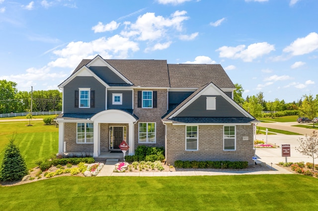 craftsman-style home featuring a front yard