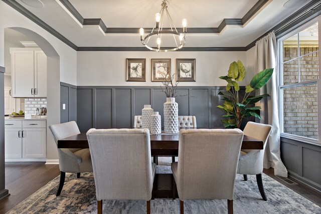 00 Hidden River Dr, Armada, MI 48005 - dining space featuring crown molding, a decorative wall, a chandelier, a raised ceiling, and arched walkways