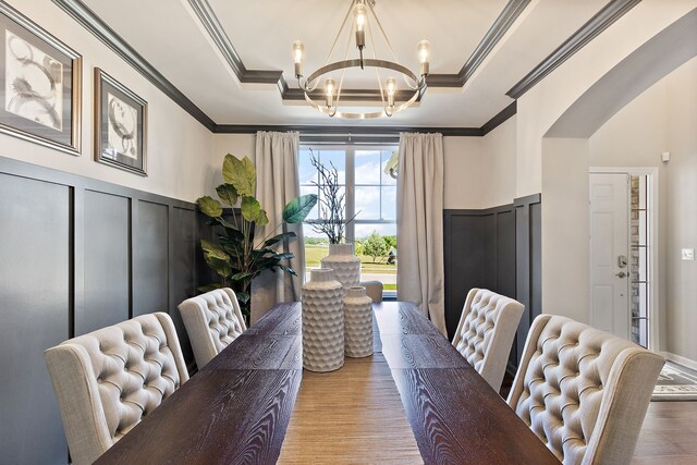 00 Hidden River Dr, Armada, MI 48005 - dining space with a chandelier, arched walkways, ornamental molding, wood finished floors, and a decorative wall