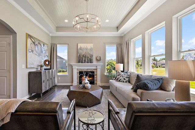 living room with wooden ceiling, dark hardwood / wood-style floors, a notable chandelier, crown molding, and a tray ceiling