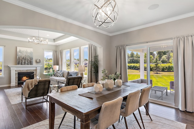 dining area featuring a chandelier, dark hardwood / wood-style flooring, and a healthy amount of sunlight