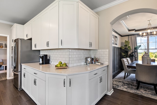 kitchen featuring white cabinetry, crown molding, and dark wood-type flooring