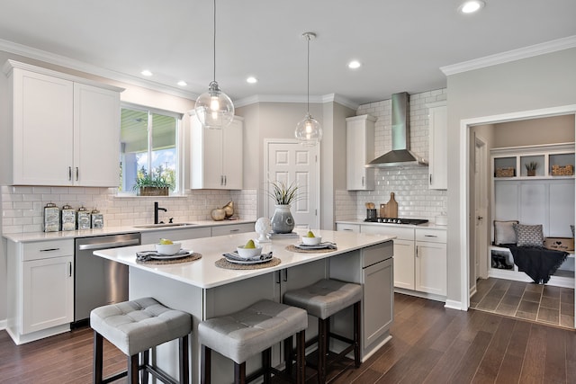 kitchen with white cabinetry, dishwasher, sink, dark wood-type flooring, and wall chimney range hood