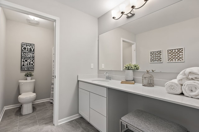 bathroom featuring tile patterned floors, vanity, and toilet