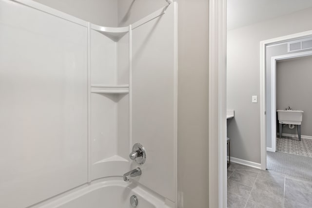 bathroom featuring tile patterned flooring and tub / shower combination