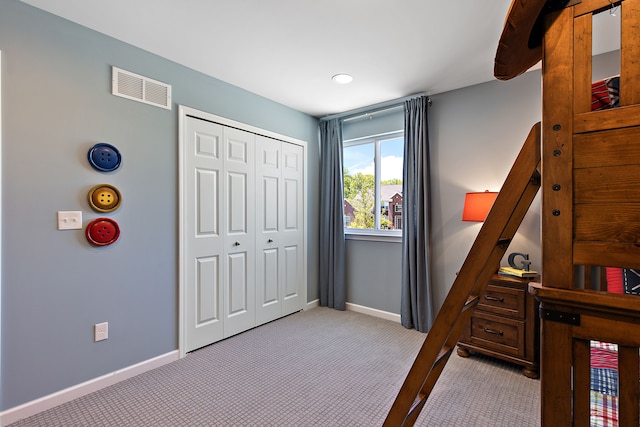 bedroom with a closet and light colored carpet