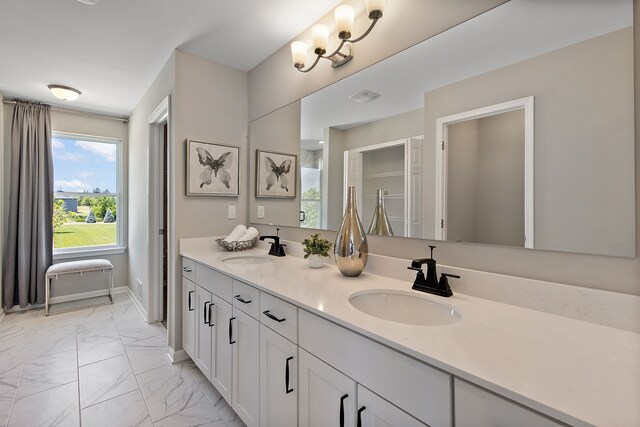 00 Hidden River Dr, Armada, MI 48005 - bathroom featuring double vanity, marble finish flooring, and baseboards