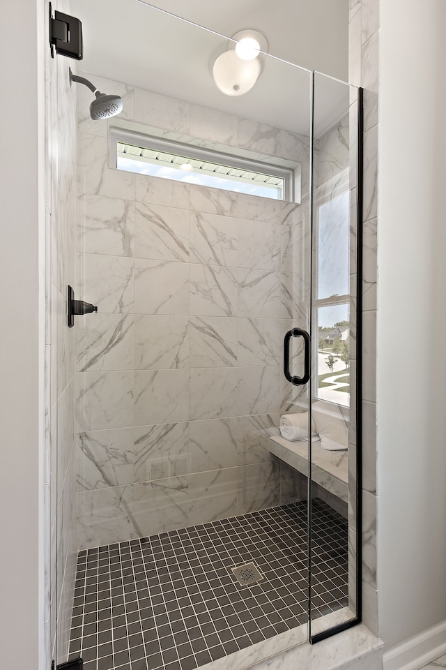 bathroom with a shower with shower door