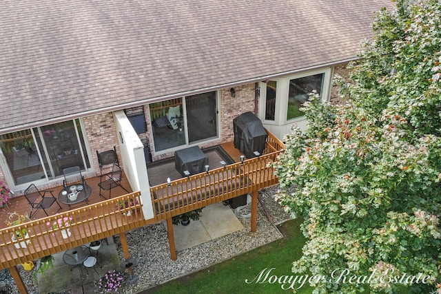 wooden terrace with a grill