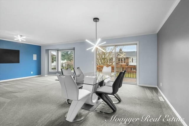 dining room featuring carpet, crown molding, baseboards, and an inviting chandelier