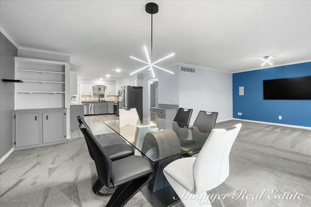 dining space featuring light carpet, visible vents, baseboards, ornamental molding, and an inviting chandelier