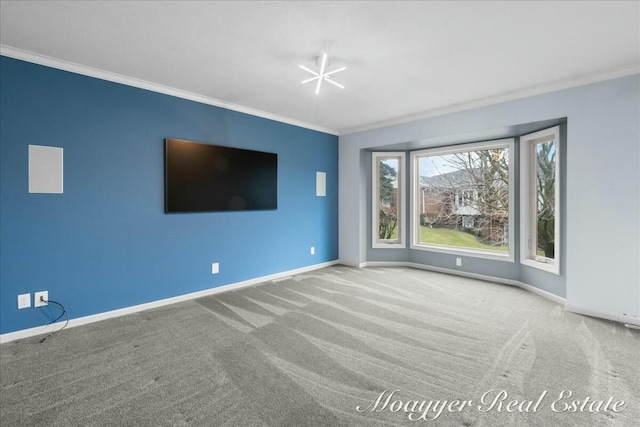 unfurnished living room with carpet floors, ornamental molding, and baseboards