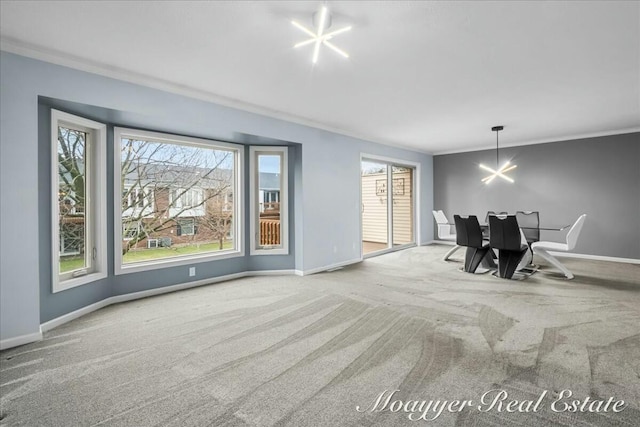 dining space with carpet floors, baseboards, and crown molding