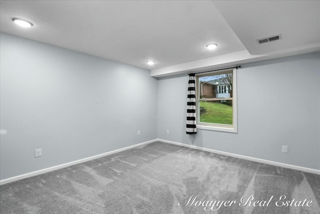 carpeted empty room with visible vents and baseboards