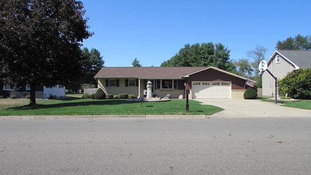 view of front of property with a front yard and a garage