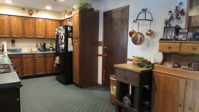 kitchen featuring black refrigerator